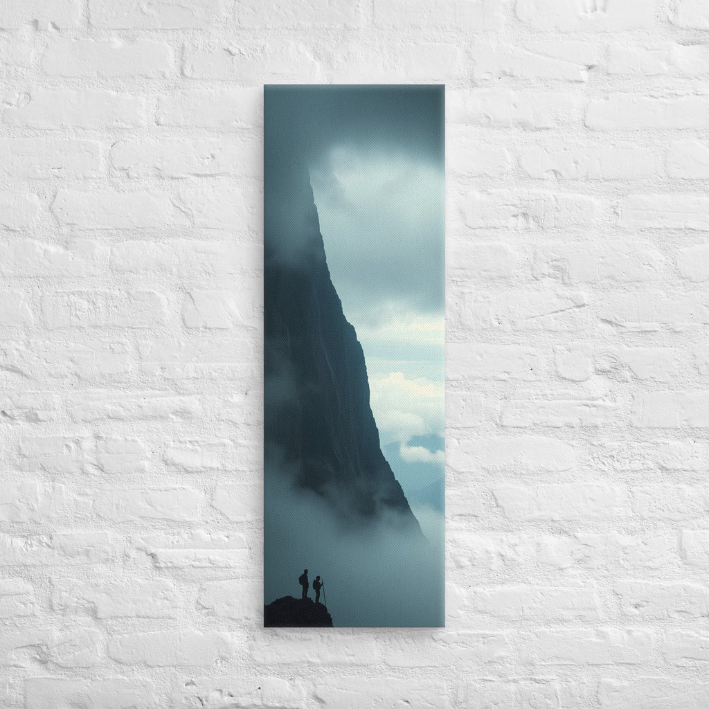 Beside the Mountain Wall, tall wrapped canvas print: two small figures on a rocky ledge beside a towering mist-shrouded mountain wall.