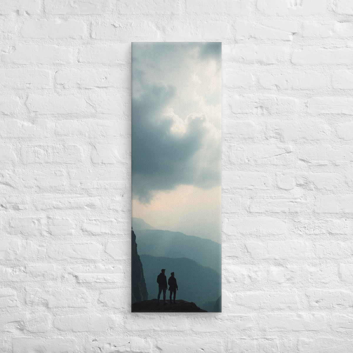 Across the Blue Ridges, tall wrapped canvas print: two figures on a cliff edge overlooking layered blue mountain ridges with slanting sunbeams.