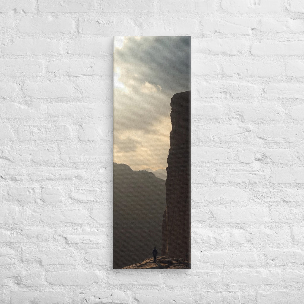 The Sunlit Shelf, tall wrapped canvas print: a lone figure on a sun-warmed rock shelf beside a towering cliff wall.