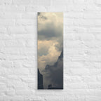 The Valley of Clouds, tall wrapped canvas print: two figures on a ridge between dark peaks above a valley filled with cloud.
