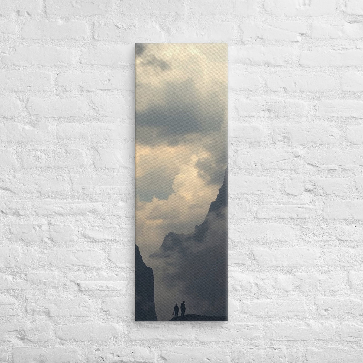 The Valley of Clouds, tall wrapped canvas print: two figures on a ridge between dark peaks above a valley filled with cloud.