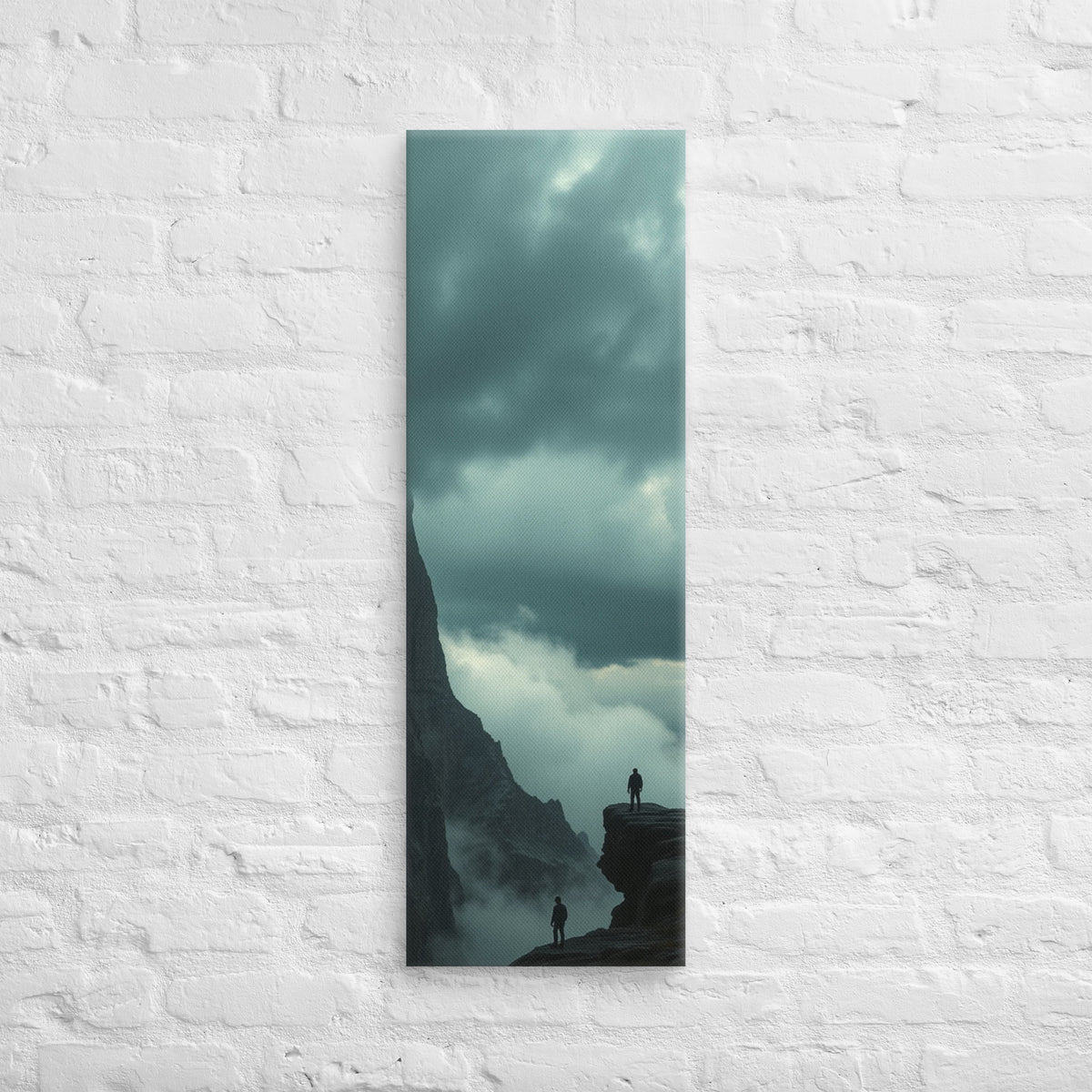 On Separate Ledges, tall wrapped canvas print: two figures standing apart on separate rocky pinnacles amid streaming clouds.