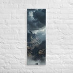 The Valley Below, tall wrapped canvas print: two figures on rocks looking down into a misty valley of dark storm-capped peaks.