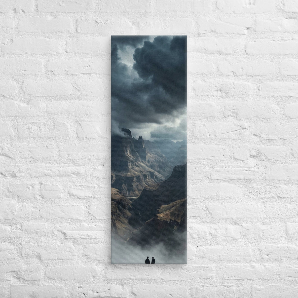 The Valley Below, tall wrapped canvas print: two figures on rocks looking down into a misty valley of dark storm-capped peaks.