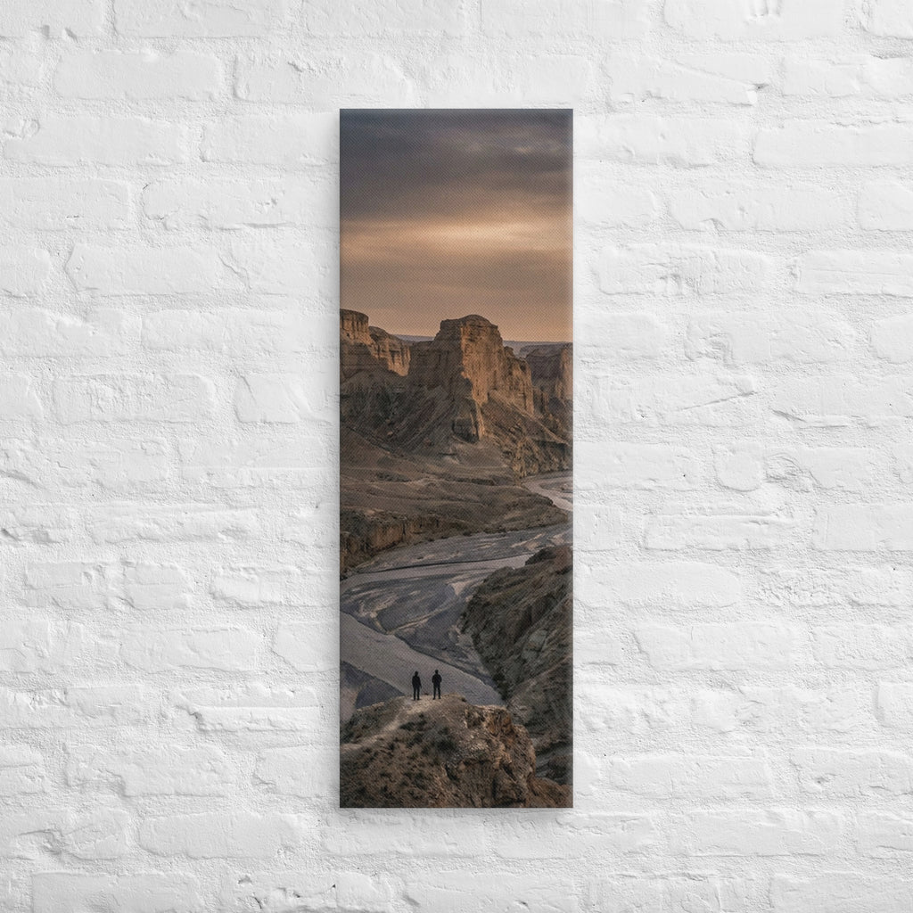 The River Beyond the Ridge, tall wrapped canvas print: three figures on a ridge above a river winding through a dusk-lit canyon.