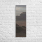 The Desert Stillness, tall wrapped canvas print: three figures in a vast hazy desert with a lone mesa in the distance.