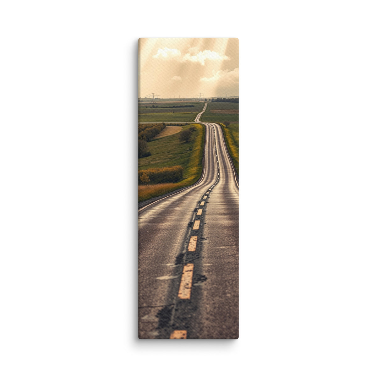 The Long Way Home, tall wrapped canvas print: a long empty road through green and gold farmland stretching to a luminous horizon under breaking sun-shafts.