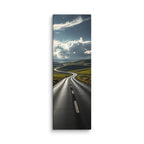 Through The Green Folds, tall wrapped canvas print: a winding road through green rolling hills under towering white cumulus clouds.