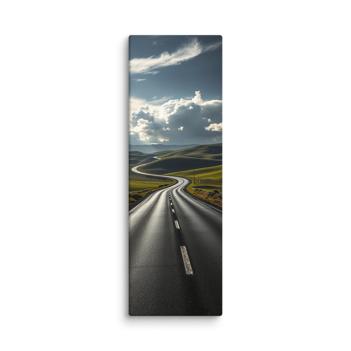Through The Green Folds, tall wrapped canvas print: a winding road through green rolling hills under towering white cumulus clouds.
