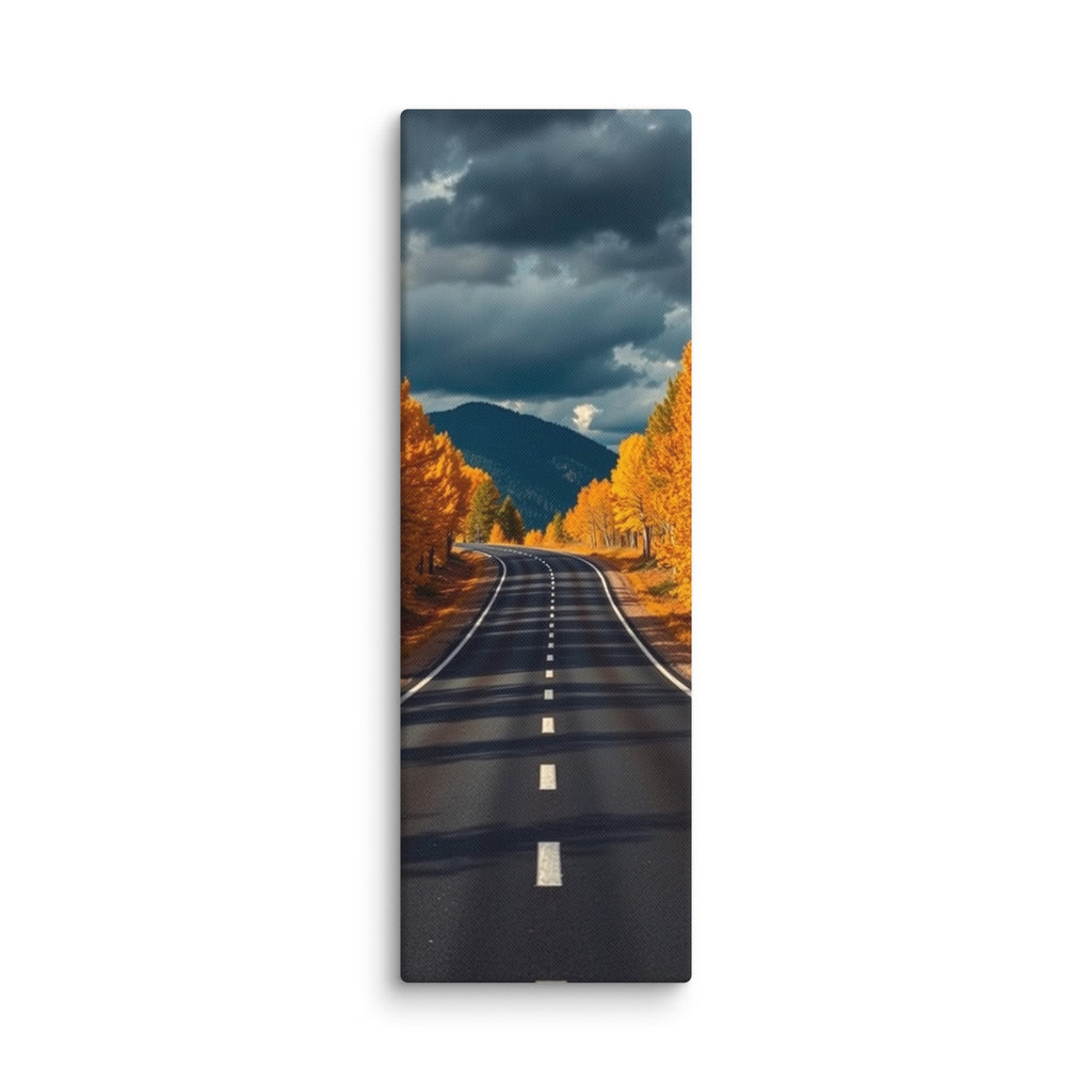 The Last Turn Of Autumn, tall wrapped canvas print: a winding road through golden autumn trees toward a dark mountain under heavy storm clouds.