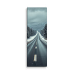 Through The Quiet Pines, tall wrapped canvas print: a wet road winding through a snow-dusted pine forest toward misty blue mountains.