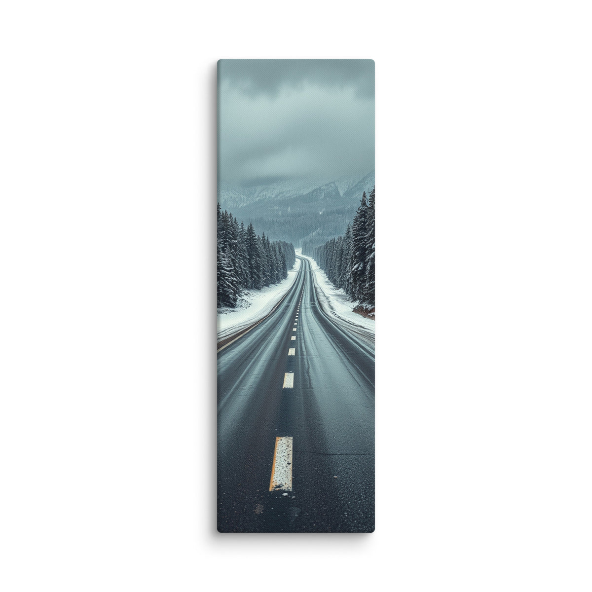 Through The Quiet Pines, tall wrapped canvas print: a wet road winding through a snow-dusted pine forest toward misty blue mountains.