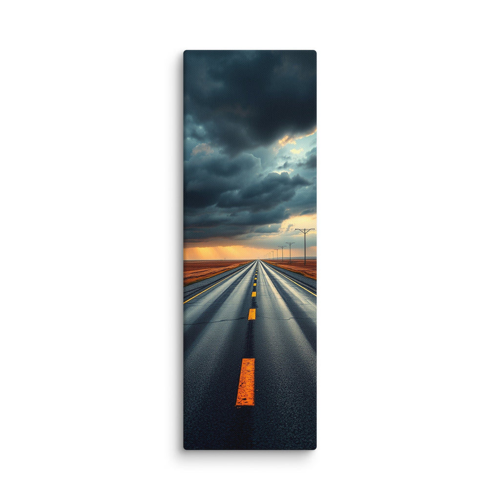 At The Edge Of The Storm, tall wrapped canvas print: a long straight road across russet plains under massive dark storm clouds with amber sunset light on the horizon.