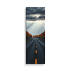 A Break In The Heavens, tall wrapped canvas print: brilliant sunbeams splitting dark storm clouds over a straight road through orange autumn forest.