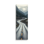 The Silver Approach, tall wrapped canvas print: a serpentine wet road through a silver-grey misty mountain valley.