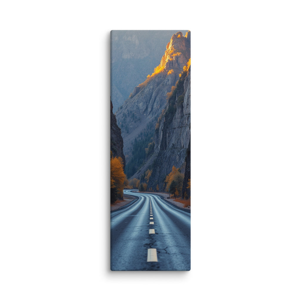 The Gilded Ramparts, tall wrapped canvas print: a road through a canyon with golden evening light gilding the upper cliffs and autumn trees.
