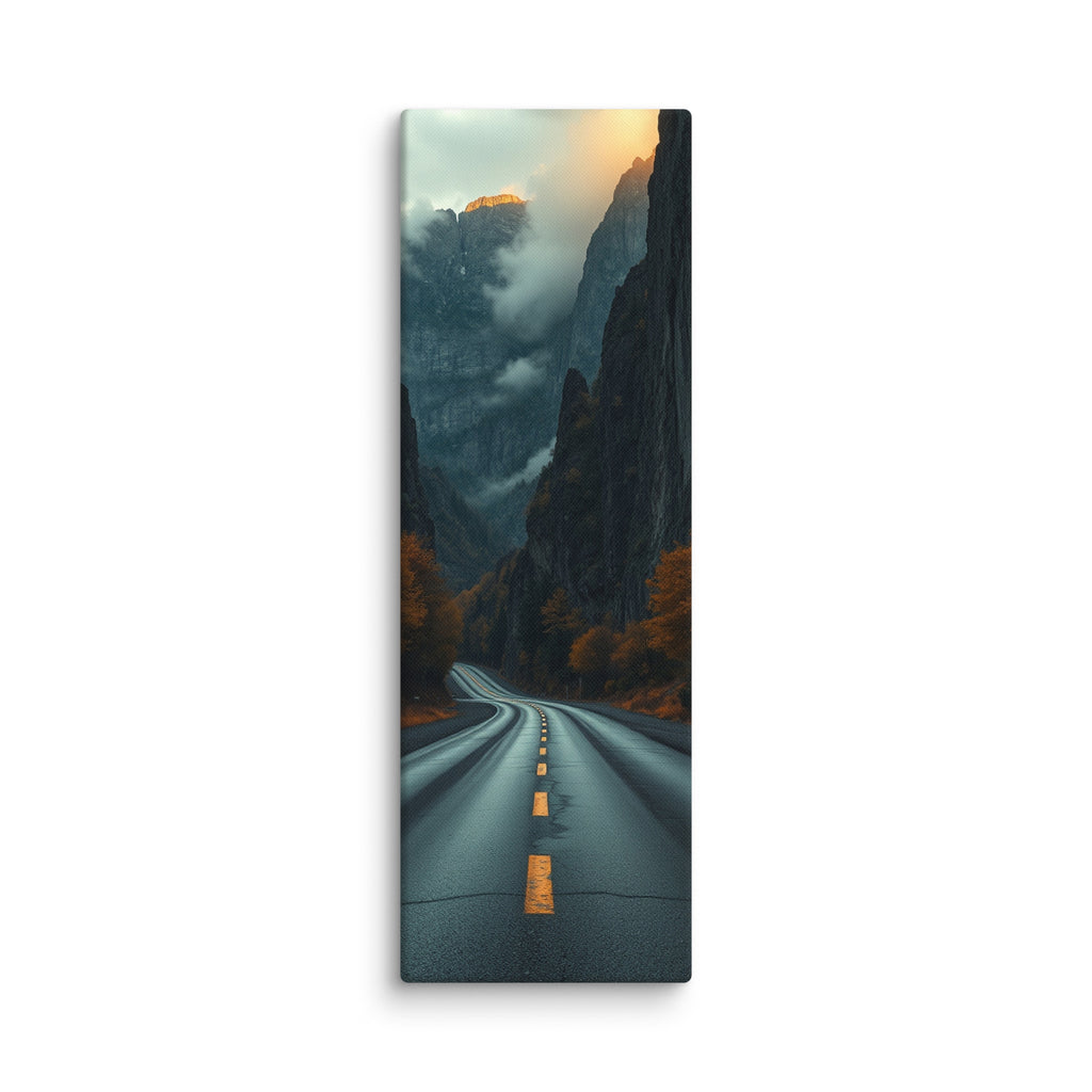 Into The Hidden Pass, tall wrapped canvas print: a road running into a dark gorge between towering cliffs with a sunlit golden peak above the mist.