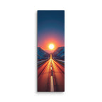 A Valley Of Fire, tall wrapped canvas print: a road running straight into a blazing red-orange sunset between snow-dusted mountains.