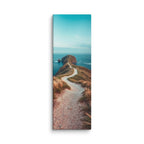 The Sea At The End, tall wrapped canvas print: a white path along a grassy coastal ridge leading to a rocky headland between ocean waters.