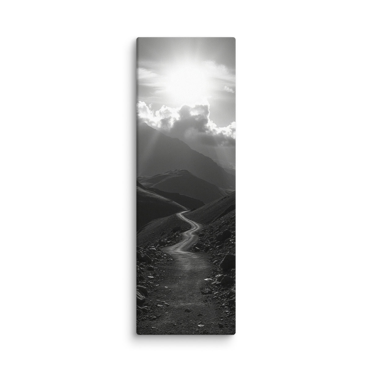 The Silent Ascent, tall wrapped canvas print: a black-and-white winding mountain path climbing toward sunlight breaking through clouds.