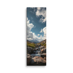 An Answer From The Mountains, tall wrapped canvas print: a rocky stream flowing toward a snow-capped mountain under dramatic clouds.
