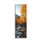 The Last Leaves Drift, tall wrapped canvas print: golden autumn trees leaning over a stream with leaves drifting on the water.