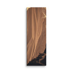 The Molten Falls, tall wrapped canvas print: a vast golden cliff face flowing like molten rock with a lone figure on the path below.