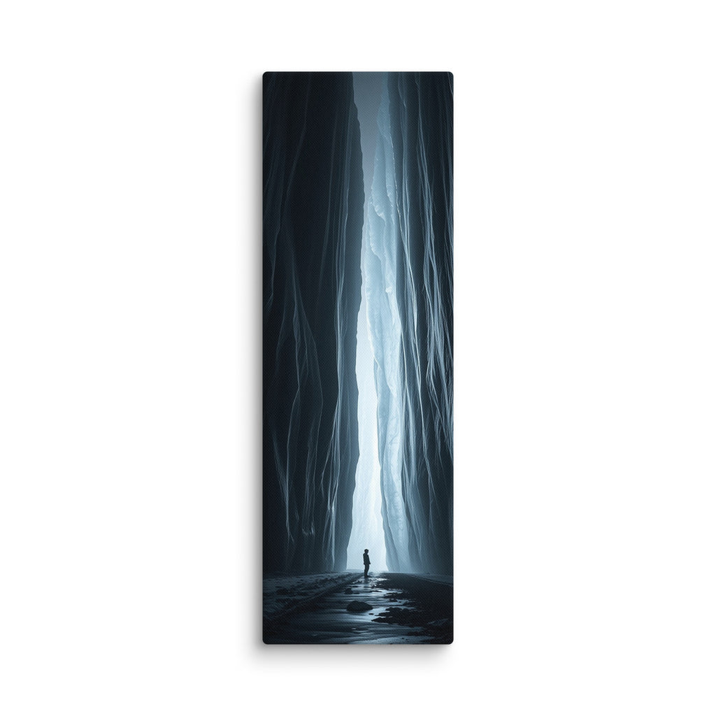 A Blade Of Light, tall wrapped canvas print: a vertical shaft of icy light cutting through a dark slot canyon with a lone figure.