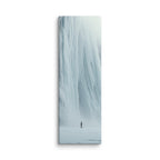 A Measure Of Stillness, tall wrapped canvas print: a lone figure before a massive soft white frozen waterfall with mist at its base.