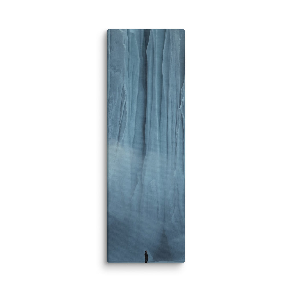 Blue Citadel, tall wrapped canvas print: a lone figure before an immense wall of pale blue ice columns rising into mist.