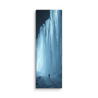 The Blue Monolith, tall wrapped canvas print: a lone figure beside a massive glowing blue-white icefall wall at night.