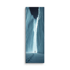 The Night Cleft, tall wrapped canvas print: footprints in snow leading to a lone figure before a luminous ice cleft at night.