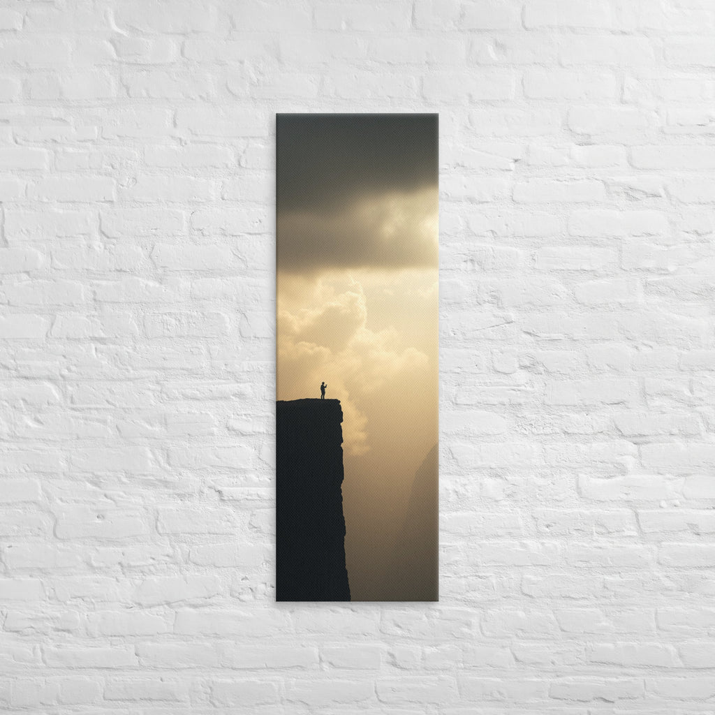 The Edge of Gold, tall wrapped canvas print: a tiny silhouetted figure at the edge of a black cliff against a luminous gold sky.