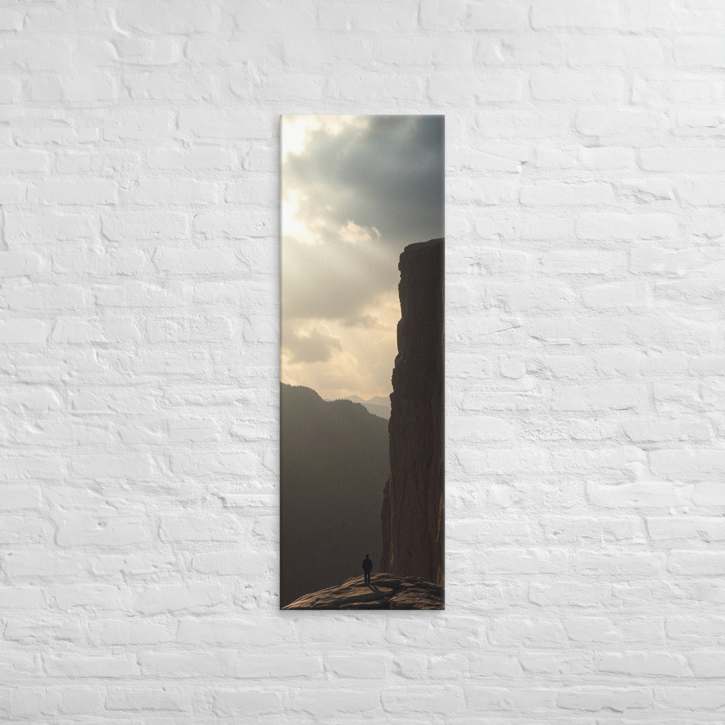 The Sunlit Shelf, tall wrapped canvas print: a lone figure on a sun-warmed rock shelf beside a towering cliff wall.