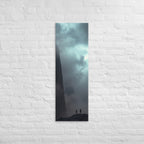 Under the Sheer Wall, tall wrapped canvas print: two small figures beneath a sheer cliff wall rising into cloud.