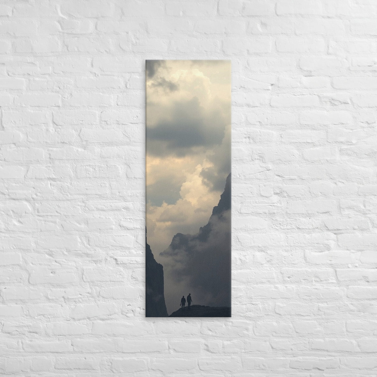 The Valley of Clouds, tall wrapped canvas print: two figures on a ridge between dark peaks above a valley filled with cloud.