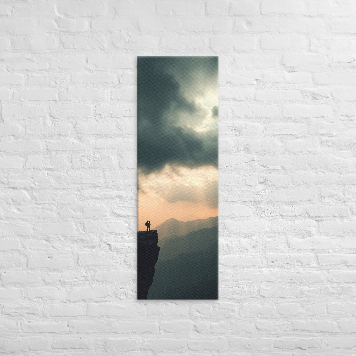 The Amber Distance, tall wrapped canvas print: two figures on a cliff edge facing an amber sunset sky with light rays over layered ridges.