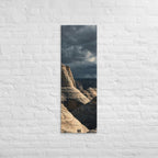 Among the Sandstone Folds, tall wrapped canvas print: two figures among pale wave-folded sandstone formations under a dark sky.