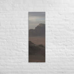 The Desert Stillness, tall wrapped canvas print: three figures in a vast hazy desert with a lone mesa in the distance.