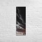 Beneath the Dark Sweep, tall wrapped canvas print: two figures on a plain beneath a vast dark sweep of cloud with a pink horizon.
