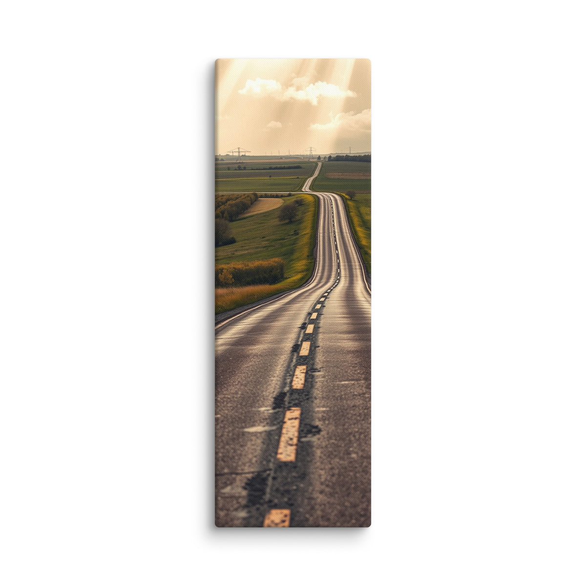 The Long Way Home, tall wrapped canvas print: a long empty road through green and gold farmland stretching to a luminous horizon under breaking sun-shafts.