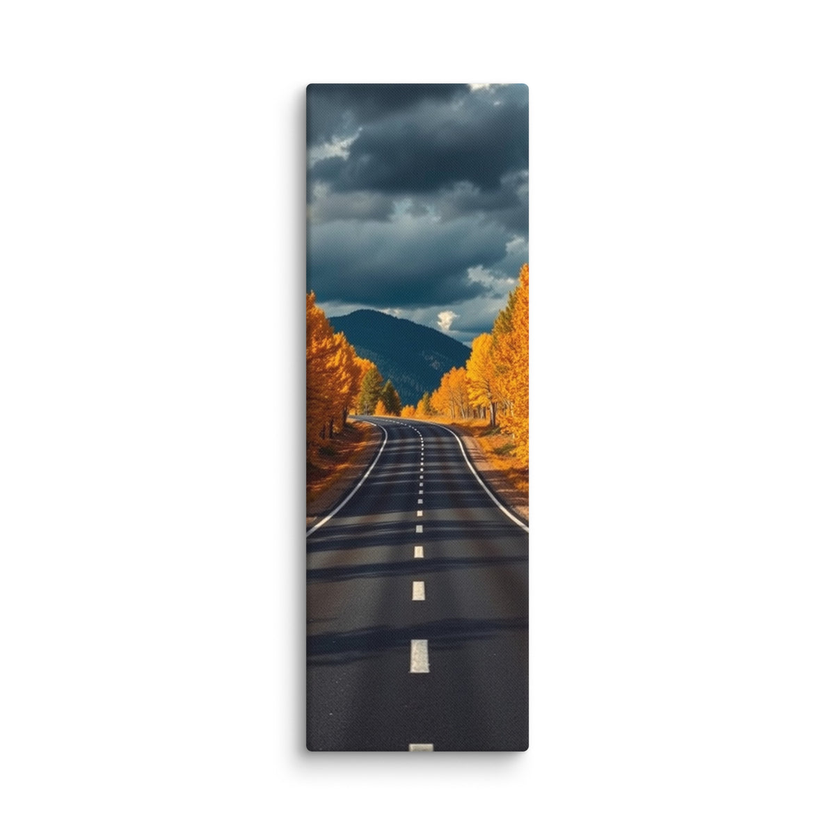 The Last Turn Of Autumn, tall wrapped canvas print: a winding road through golden autumn trees toward a dark mountain under heavy storm clouds.