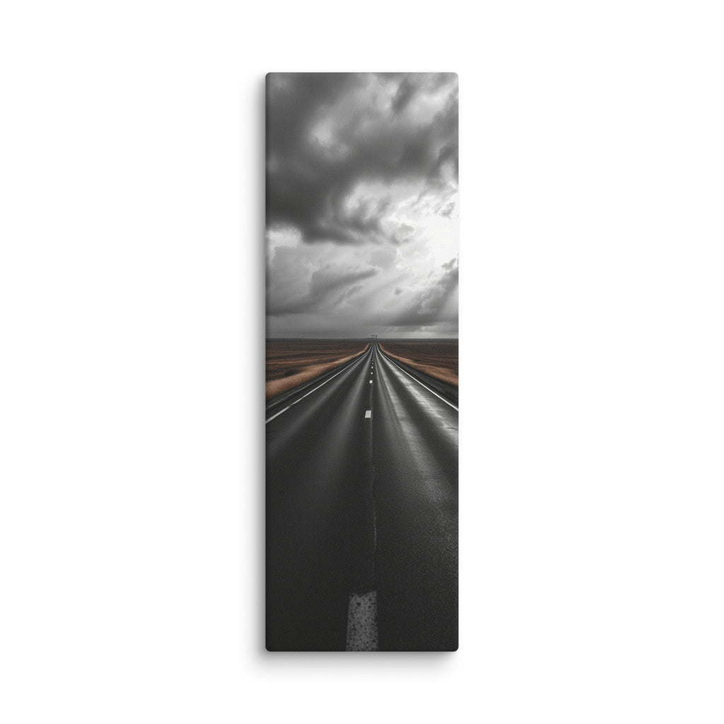 The Weight Of Weather, tall wrapped canvas print: a near-monochrome view of a road beneath an immense wall of dark storm clouds.