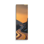 Borrowed Fire, tall wrapped canvas print: a switchback mountain road at golden hour with the asphalt catching warm fire-gold light.