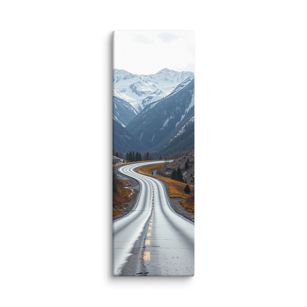 Winter Unfolding, tall wrapped canvas print: a serpentine wet road through an alpine valley with snowy peaks above and golden grasses at its edge.