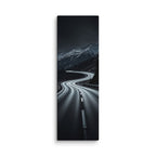 The Night Pass, tall wrapped canvas print: a dark switchback road through snowy mountains at night with distant car headlights.
