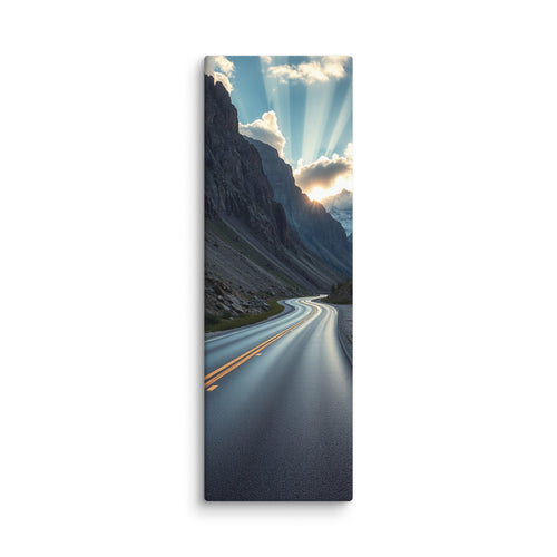 A Doorway Of Light, tall wrapped canvas print: a winding road through a rocky mountain pass with the sun bursting through clouds between peaks.