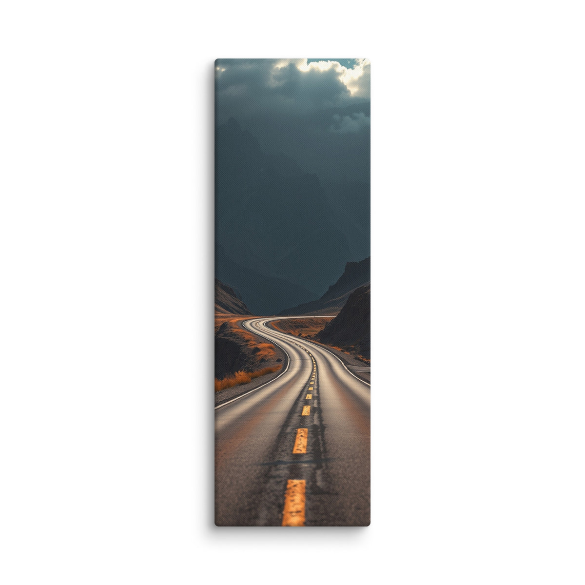 Beneath The Dark Summit, tall wrapped canvas print: a winding road through a dark mountain valley beneath brooding blue-grey peaks.