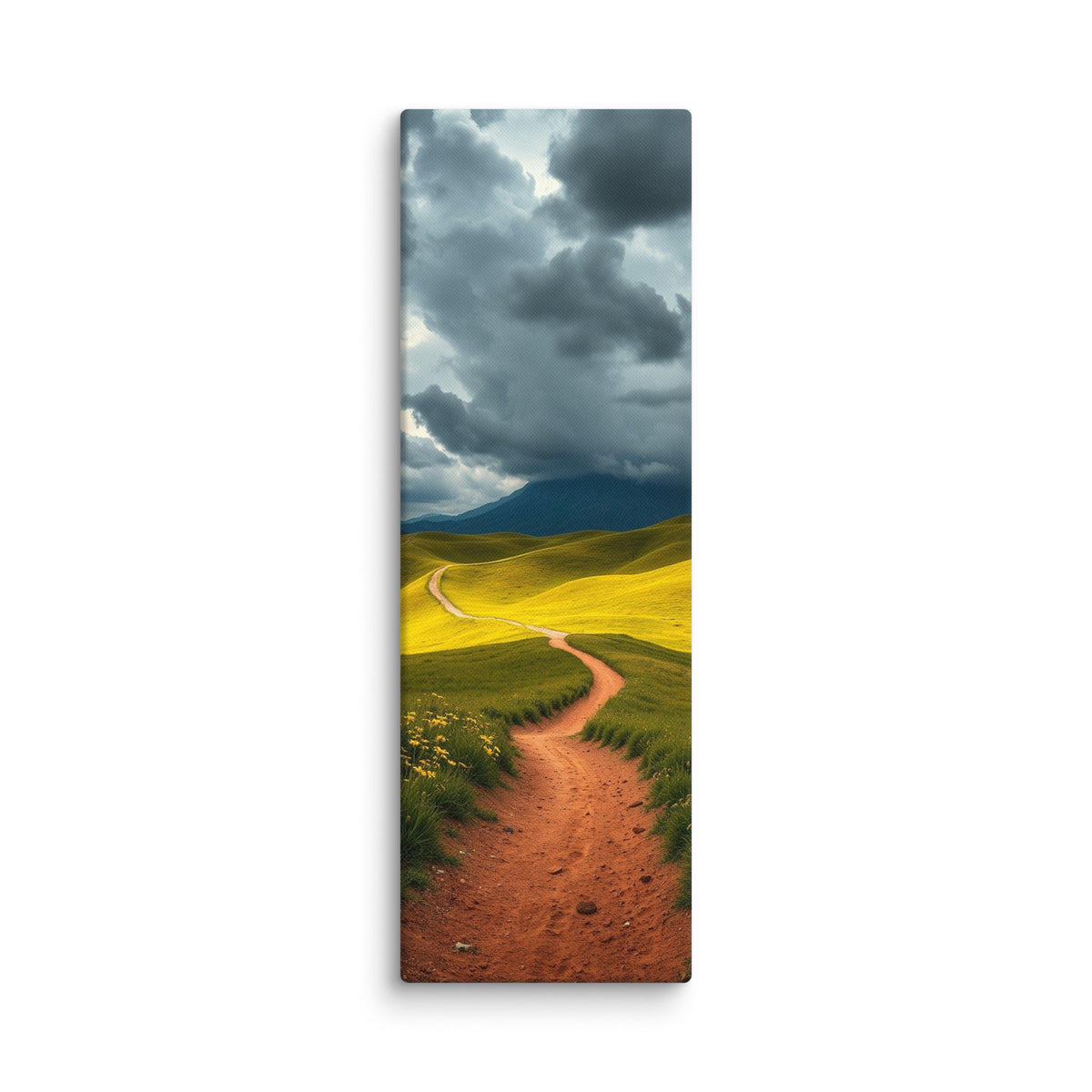 Over The Green Rise, tall wrapped canvas print: a red-earth path winding over green hills toward a dark mountain under storm clouds.