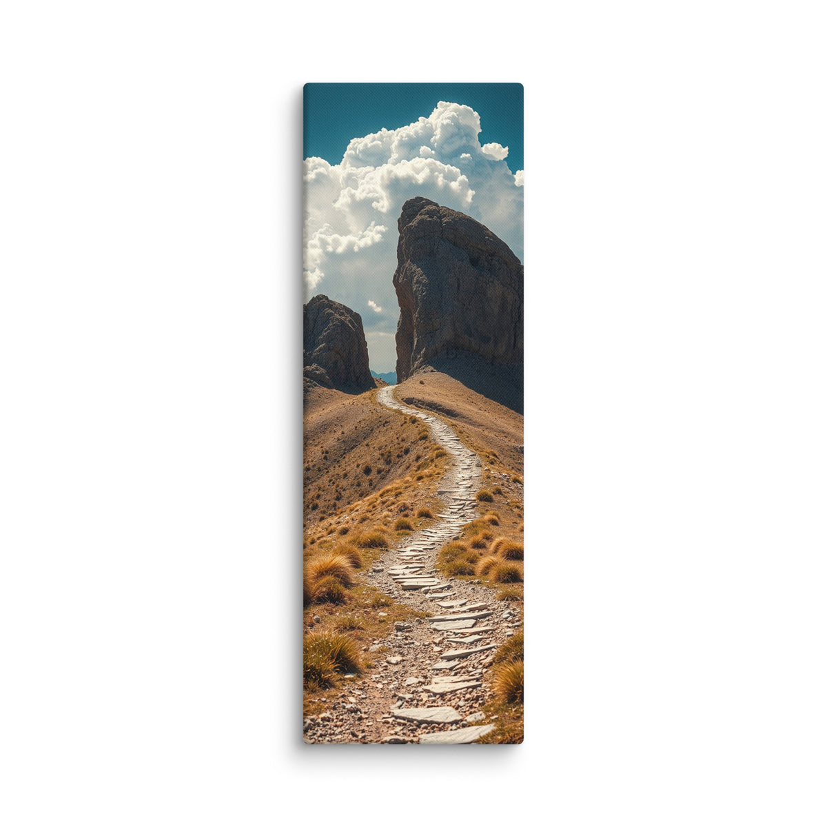 The Way Through Stone, tall wrapped canvas print: a stone-paved path passing between two massive rock towers under cumulus clouds.